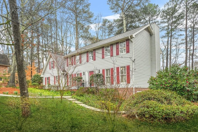 colonial house featuring a chimney