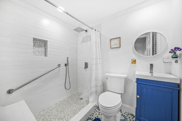 full bath with toilet, a tile shower, crown molding, baseboards, and vanity