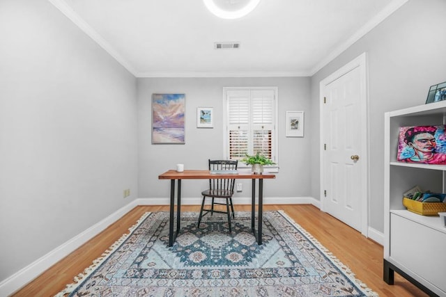 office area with visible vents, ornamental molding, baseboards, and wood finished floors