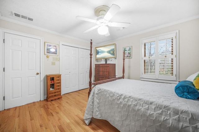 bedroom with visible vents, a closet, light wood-style floors, crown molding, and ceiling fan