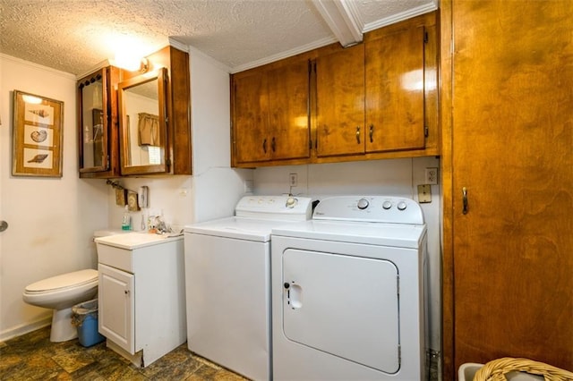 1278 Twin Pine Rd, Milledgeville, GA 31061 - laundry room with washer and clothes dryer, crown molding, a textured ceiling, and dark stone finish floors