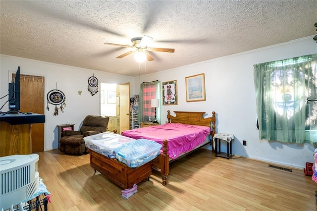 1278 Twin Pine Rd, Milledgeville, GA 31061 - bedroom featuring light wood-style floors, a textured ceiling, and a ceiling fan