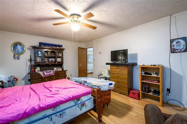 1278 Twin Pine Rd, Milledgeville, GA 31061 - bedroom featuring a textured ceiling, wood finished floors, ornamental molding, and a ceiling fan