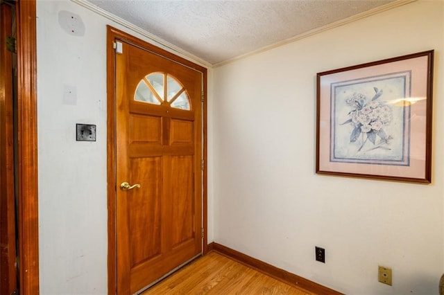 1278 Twin Pine Rd, Milledgeville, GA 31061 - foyer entrance featuring light wood-style flooring, crown molding, and a textured ceiling