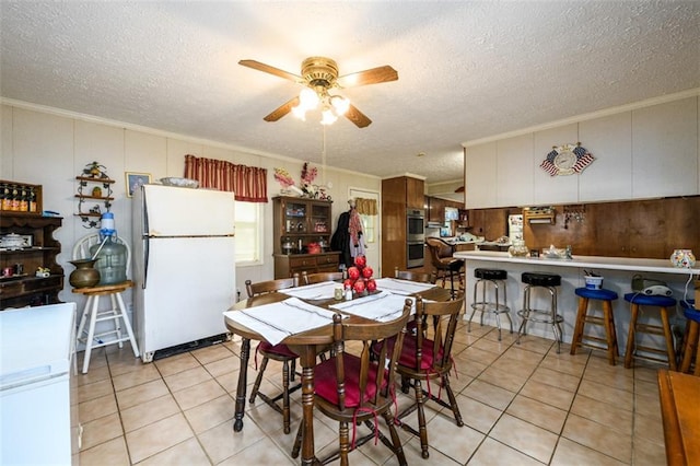 1278 Twin Pine Rd, Milledgeville, GA 31061 - dining area featuring a ceiling fan, crown molding, a textured ceiling, and light tile patterned floors