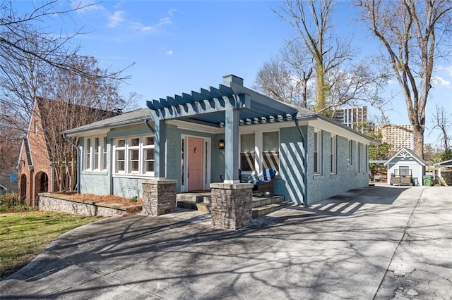 view of front of home with a porch, concrete driveway, and brick siding