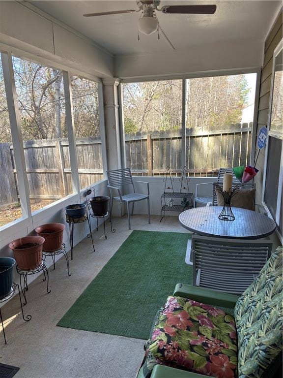 sunroom / solarium featuring ceiling fan