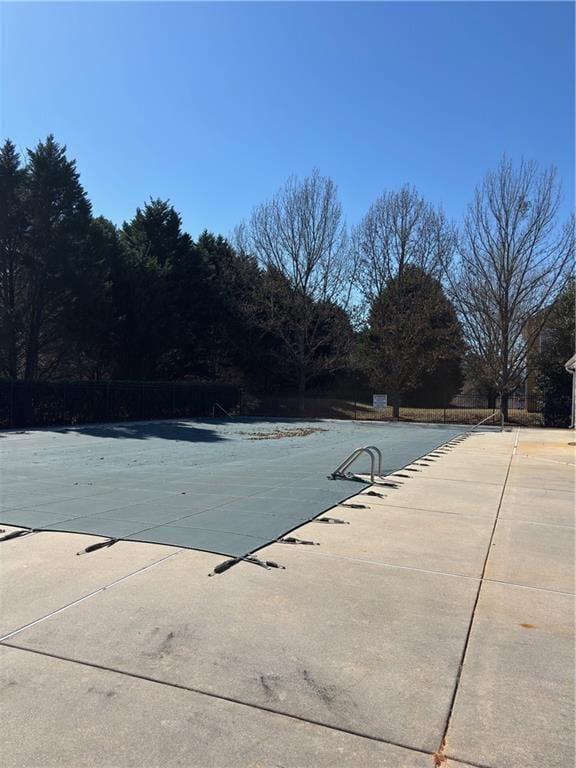 pool featuring a patio and fence