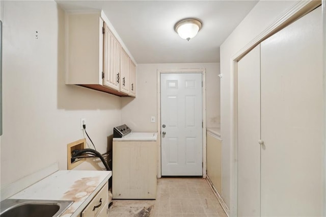 washroom with washer / dryer, cabinet space, and a sink