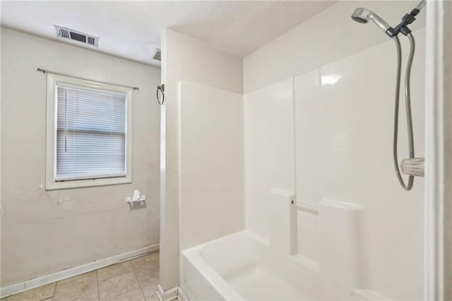 full bath with baseboards, tile patterned flooring, visible vents, and a textured ceiling