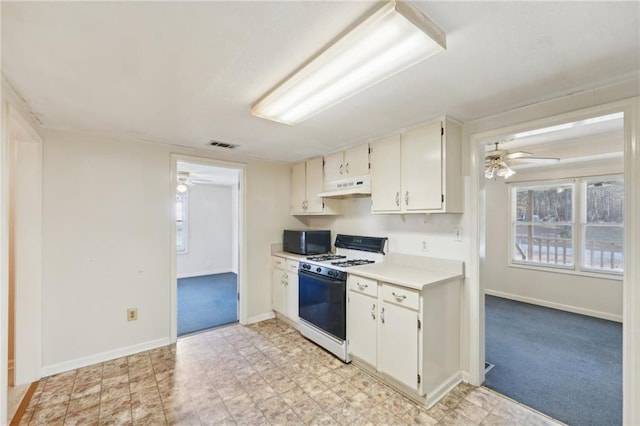 kitchen featuring black microwave, under cabinet range hood, white range with gas stovetop, visible vents, and light countertops