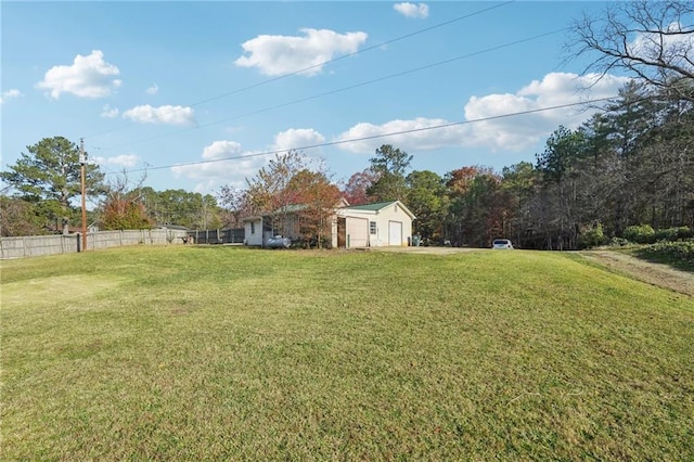 view of yard featuring fence and a detached garage