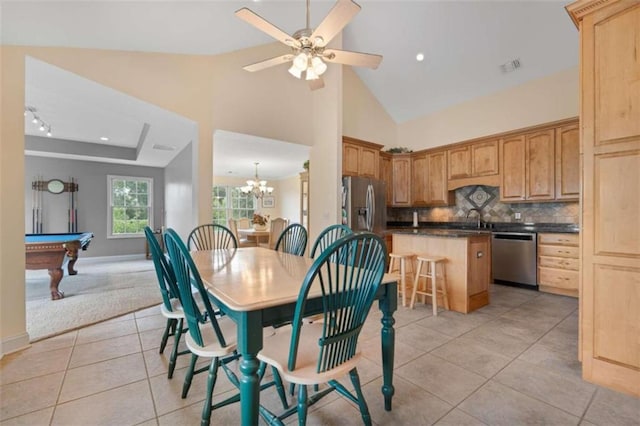 dining space with sink, high vaulted ceiling, billiards, light tile patterned floors, and ceiling fan with notable chandelier