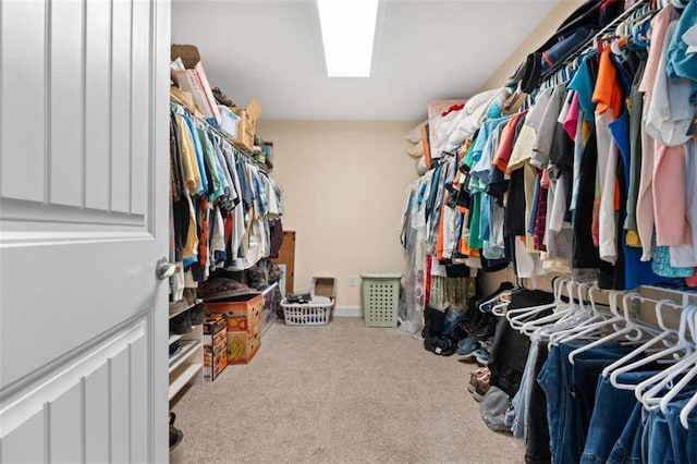 walk in closet featuring light colored carpet