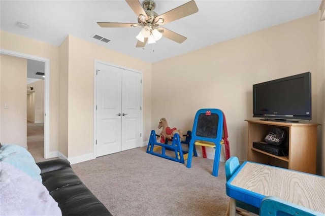 rec room featuring carpet and ceiling fan