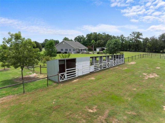 view of horse barn with a rural view