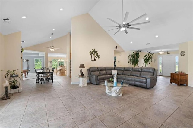 tiled living room featuring ceiling fan and high vaulted ceiling