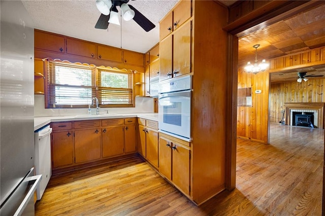 1191 S Burnt Hickory Rd, Douglasville, GA 30134 - kitchen with white appliances, a ceiling fan, wooden walls, open shelves, and light countertops