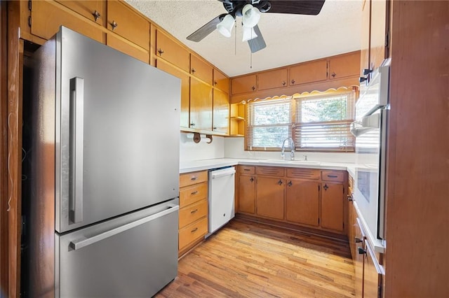 1191 S Burnt Hickory Rd, Douglasville, GA 30134 - kitchen featuring freestanding refrigerator, white dishwasher, light countertops, a ceiling fan, and light wood-type flooring