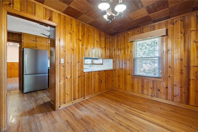 1191 S Burnt Hickory Rd, Douglasville, GA 30134 - unfurnished room featuring light wood-type flooring, a chandelier, wood walls, and wood ceiling