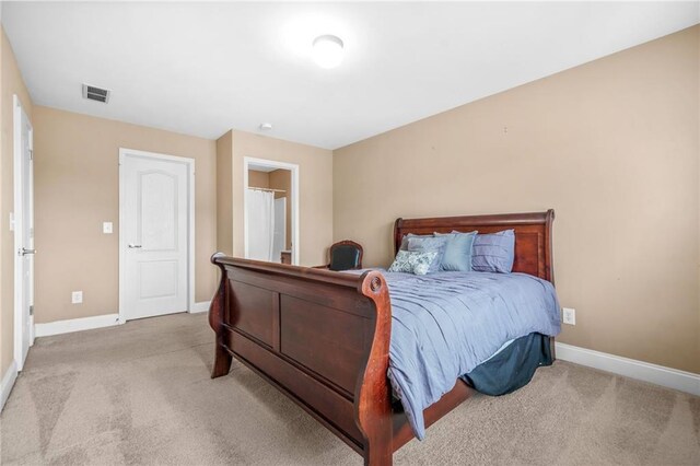 carpeted bedroom featuring visible vents and baseboards