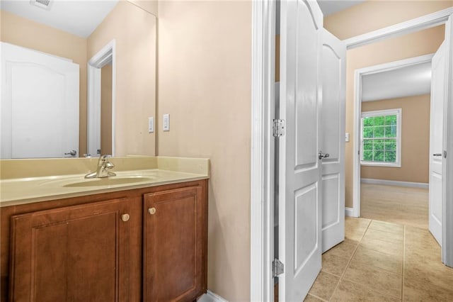 bathroom featuring vanity, baseboards, tile patterned floors, and visible vents