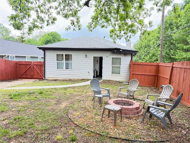 1074 Hobson St SW, Atlanta, GA 30310 - rear view of property featuring an outdoor fire pit, a fenced backyard, a gate, a chimney, and roof with shingles