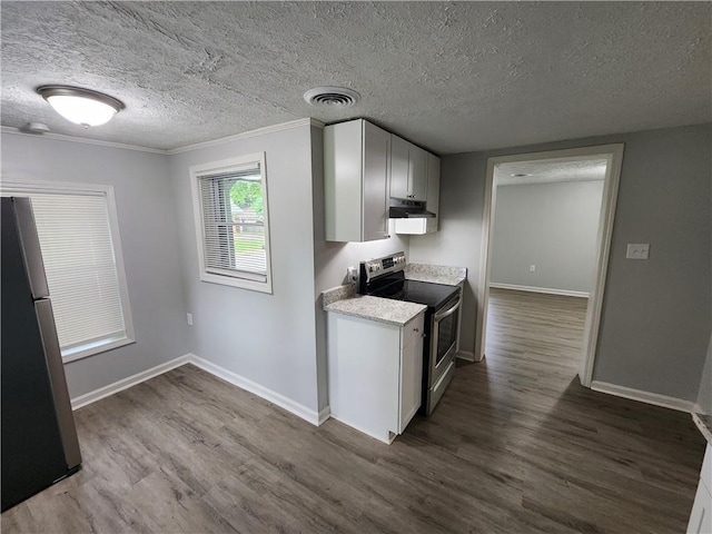 908 Davis St, Monroe, GA 30655 - kitchen with dark wood-style floors, freestanding refrigerator, visible vents, and stainless steel electric range