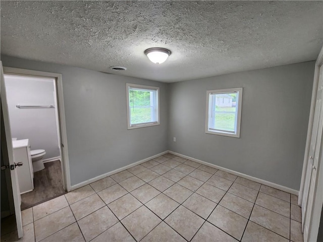 908 Davis St, Monroe, GA 30655 - unfurnished bedroom featuring multiple windows, visible vents, and baseboards