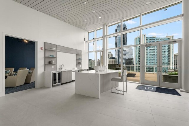 interior space with a city view, floor to ceiling windows, wood ceiling, open shelves, and modern cabinets