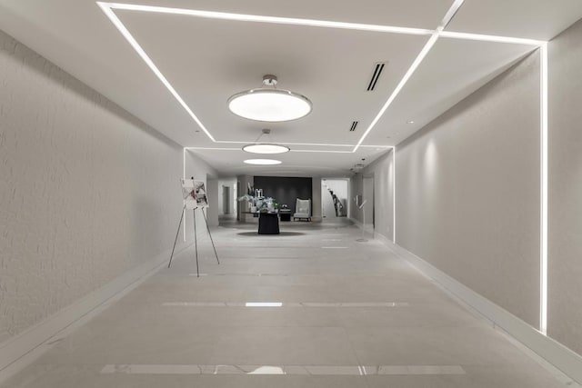 hallway with tile patterned floors and visible vents