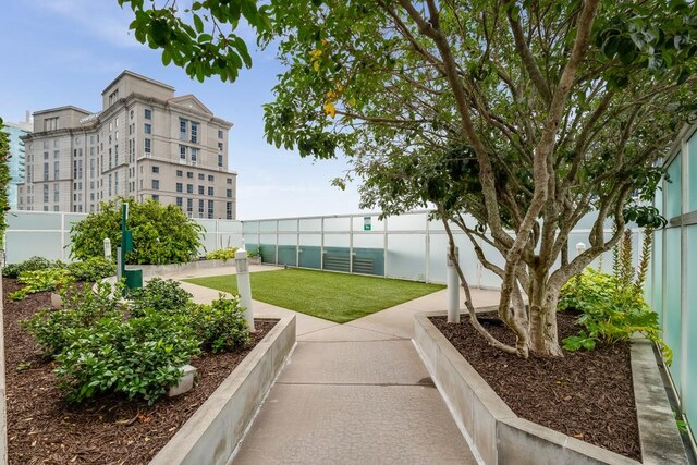 view of property's community featuring fence and a yard
