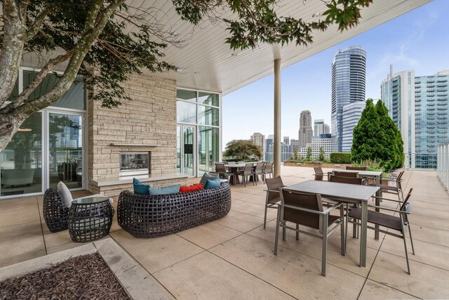 view of patio with a view of city and outdoor dining space