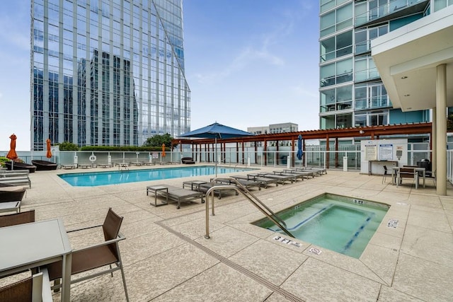 view of swimming pool with a community hot tub