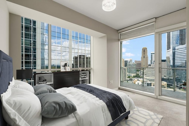 bedroom featuring carpet floors, multiple windows, and access to outside