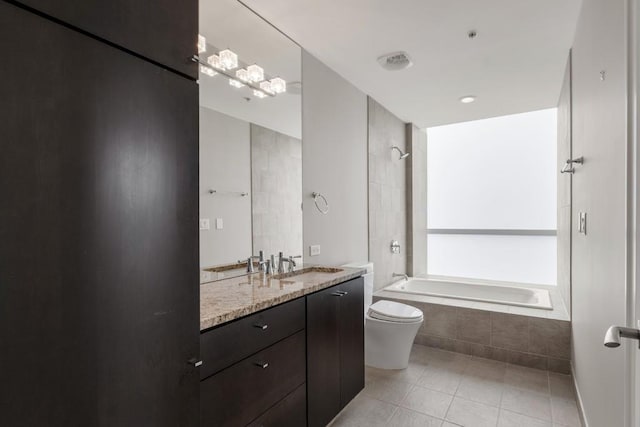full bath featuring tiled shower / bath combo, tile patterned flooring, vanity, and toilet