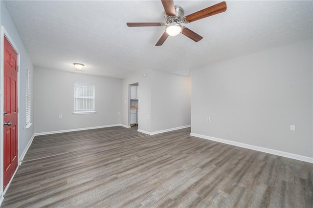 unfurnished room featuring ceiling fan, hardwood / wood-style floors, and a textured ceiling