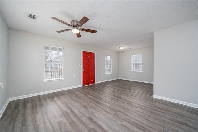 entryway featuring dark hardwood / wood-style flooring, ceiling fan, and a textured ceiling