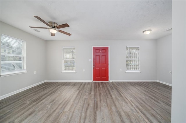 spare room with ceiling fan, hardwood / wood-style floors, and a textured ceiling