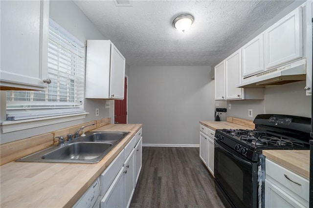 kitchen featuring black gas stove, sink, and white cabinets