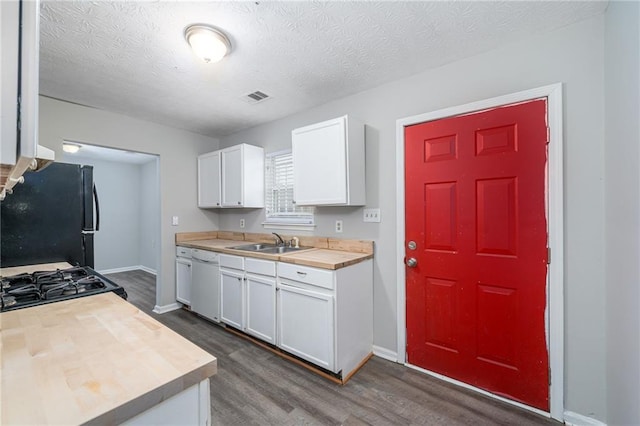 kitchen featuring dishwasher, black fridge, dark hardwood / wood-style floors, and white cabinets