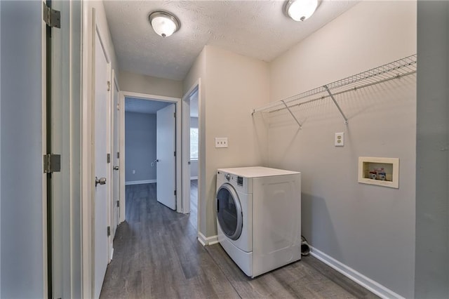 clothes washing area featuring washer / dryer, dark hardwood / wood-style floors, and a textured ceiling