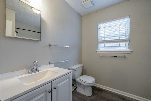 bathroom featuring vanity, toilet, and wood-type flooring