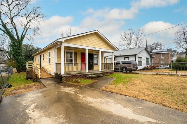 bungalow featuring a front yard and covered porch