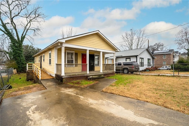718 Dalvigney St NW, Atlanta, GA 30318 - bungalow featuring a front yard and covered porch