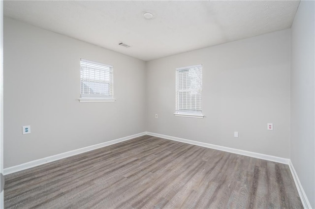 spare room with hardwood / wood-style flooring