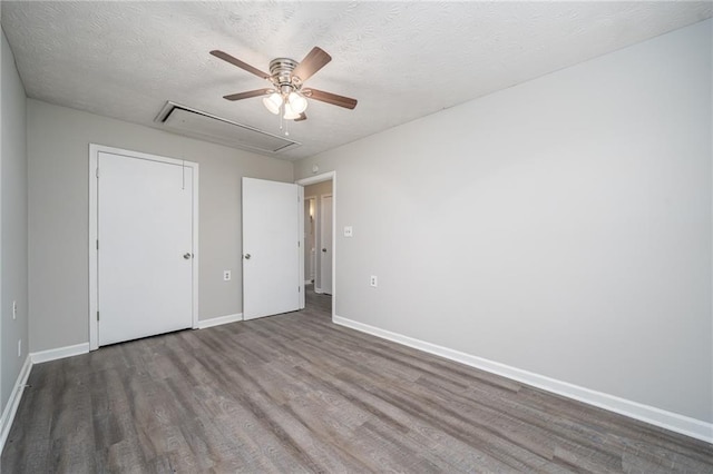 unfurnished bedroom featuring hardwood / wood-style flooring, ceiling fan, and a textured ceiling