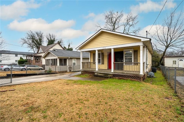 bungalow-style house featuring a porch and a front lawn