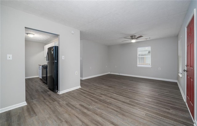 spare room with ceiling fan, dark hardwood / wood-style floors, and a textured ceiling