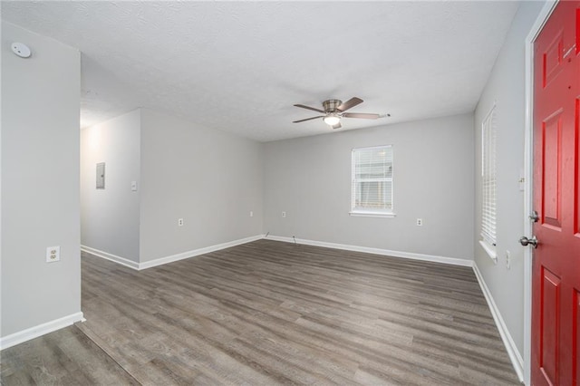 spare room featuring ceiling fan and dark hardwood / wood-style flooring